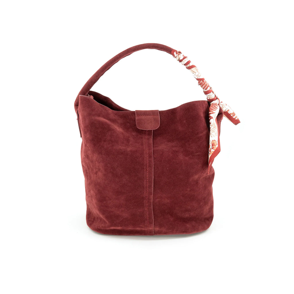 Suede bucket bag in rich burgundy with a soft texture, featuring a floral scarf accent on the handle, perfect for Long Island boutique fashion.