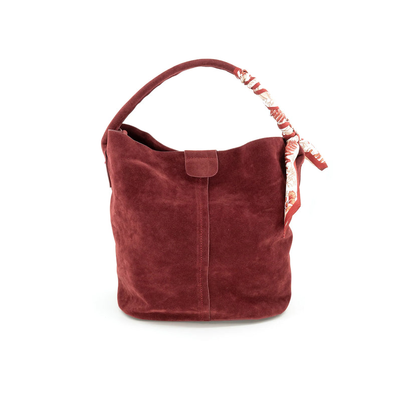 Suede bucket bag in rich burgundy with a soft texture, featuring a floral scarf accent on the handle, perfect for Long Island boutique fashion.