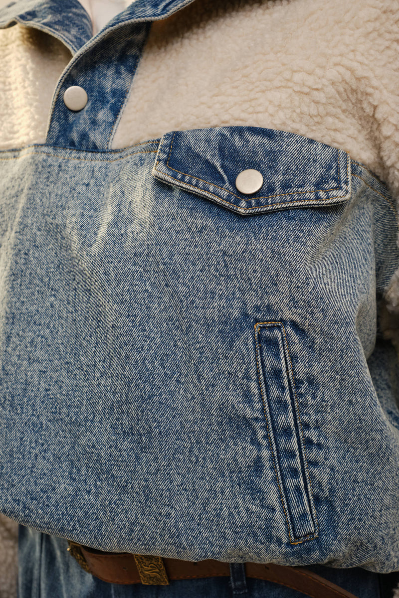 “Model wearing sherpa top with denim contrast and side pockets”
