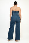 Strapless elastic tube wide leg denim jumpsuit in dark wash, featuring flattering fit and back pockets, perfect for Long Island boutique fashion.