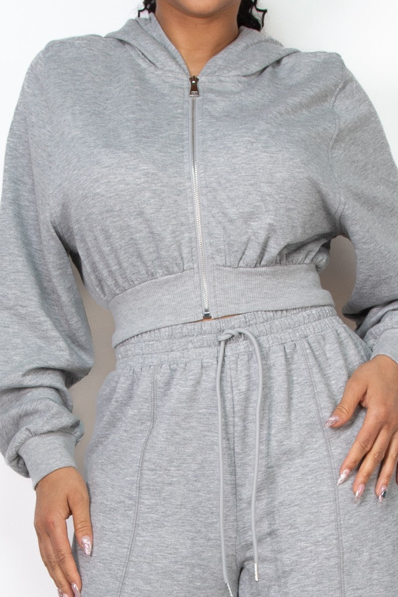 Light gray crop zip-up hoodie featuring a fitted waistband and soft fabric, perfect for a casual look from a Long Island fashion boutique.