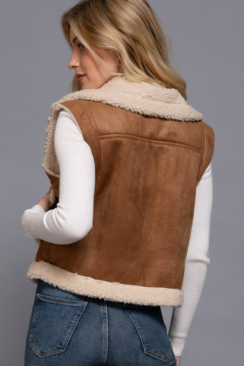 Faux suede zip-up vest in rich tan featuring a soft inner fur lining and cozy collar, perfect for Long Island boutique fashion.