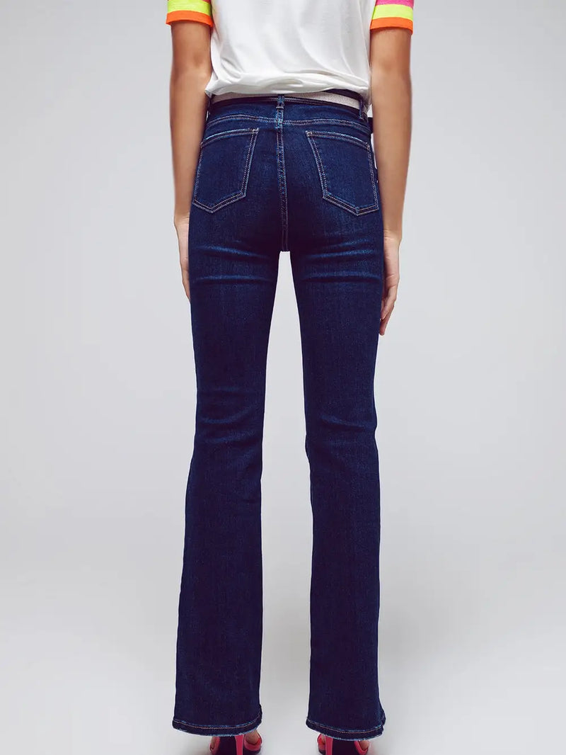 Model wearing dark wash High Waisted Flared Jeans in stretch denim — sleek, flattering fit with a subtle flare, available at TandyWear Boutique in Commack, NY. back view