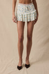 Ditsy floral front tie high waist mini skort with ruffle details, perfect for a playful summer outfit from a Long Island women’s boutique.