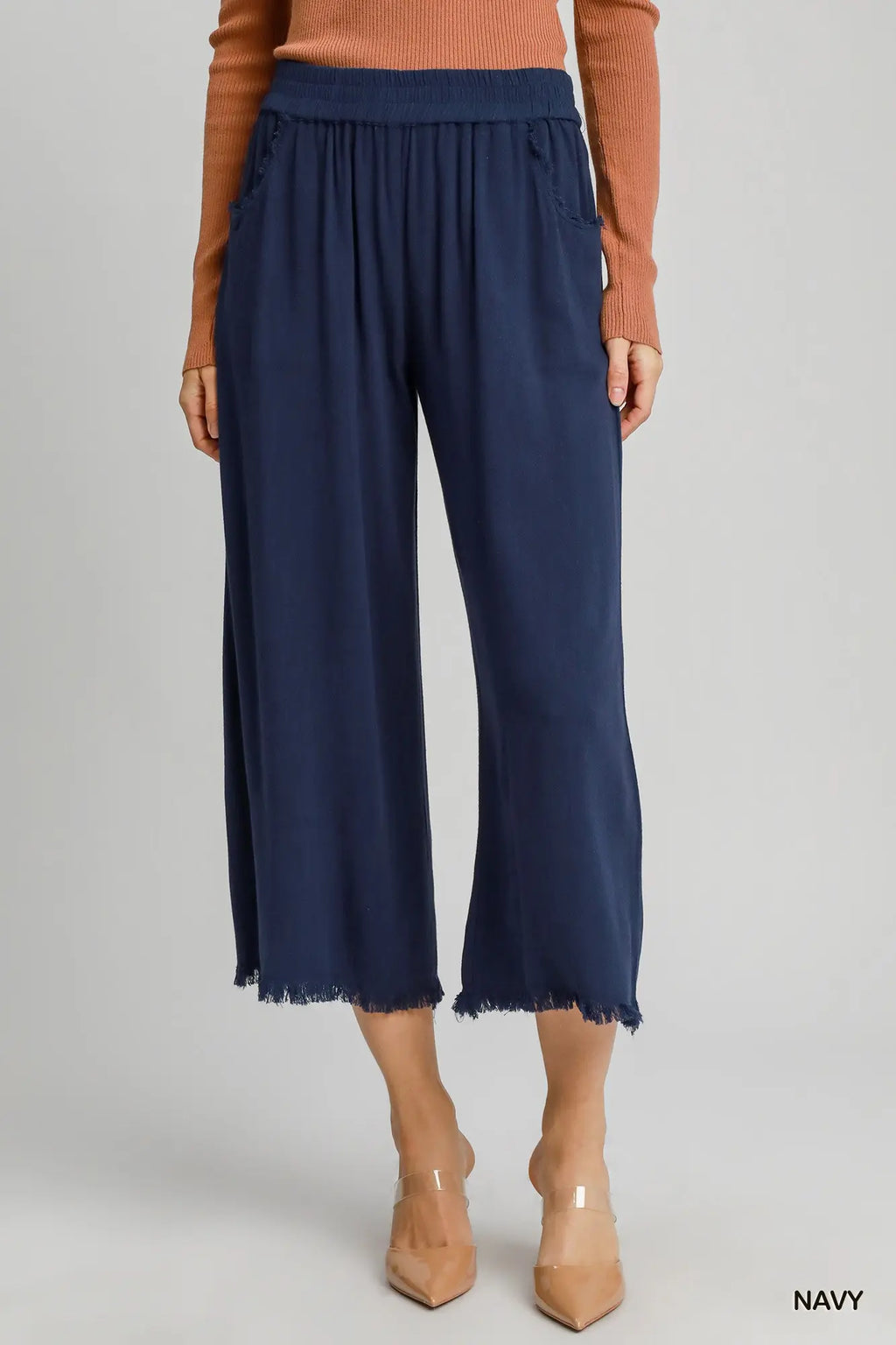 Flowy black frayed hem wide leg pants with a comfortable waistband and side pockets, perfect for stylish Long Island boutique fashion.