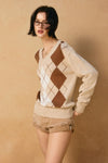 Light beige V-neck sweater featuring a brown and white argyle pattern, perfect for stylish layering in Long Island boutique fashion.