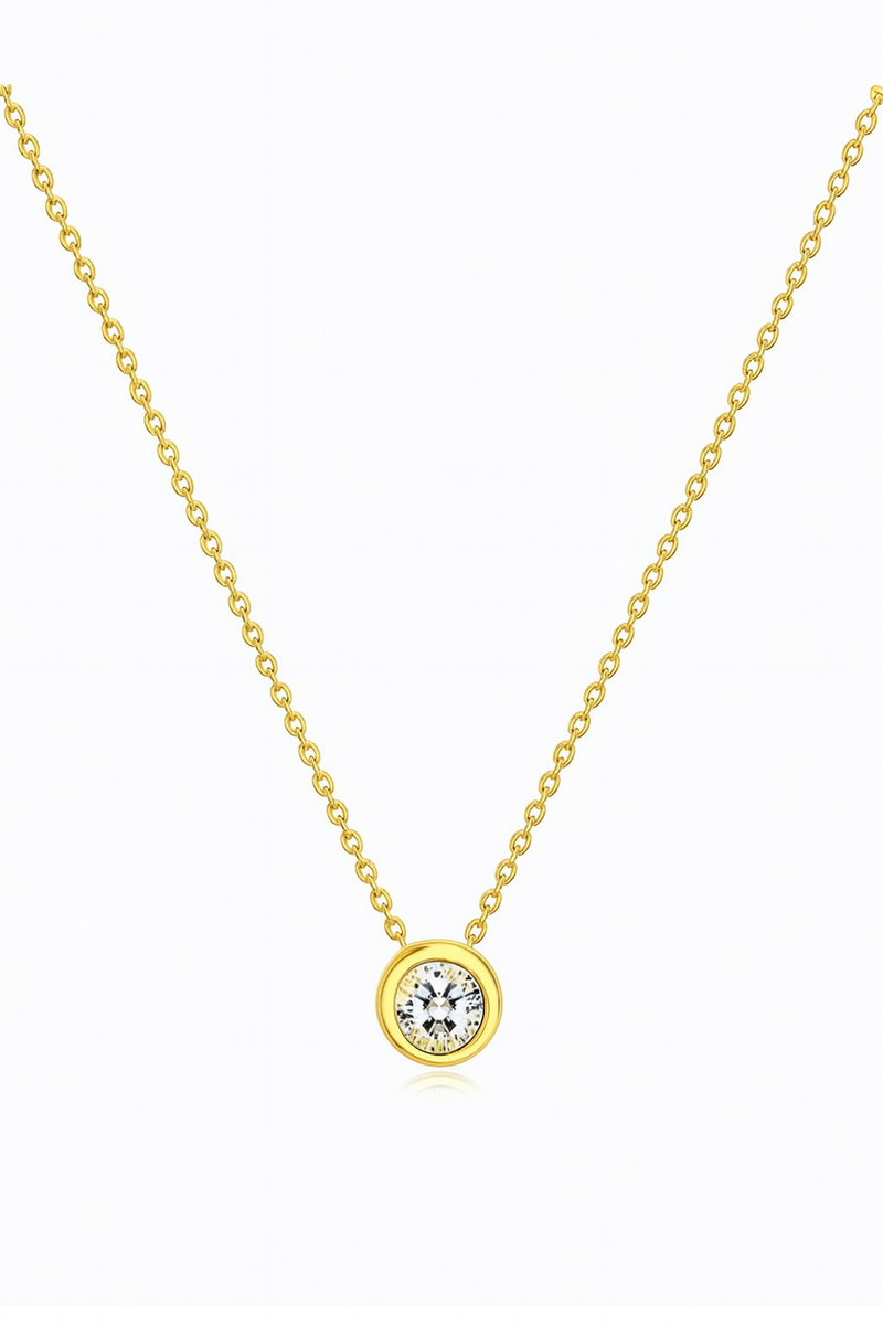 Gold necklace with a diamond pendant on a white background