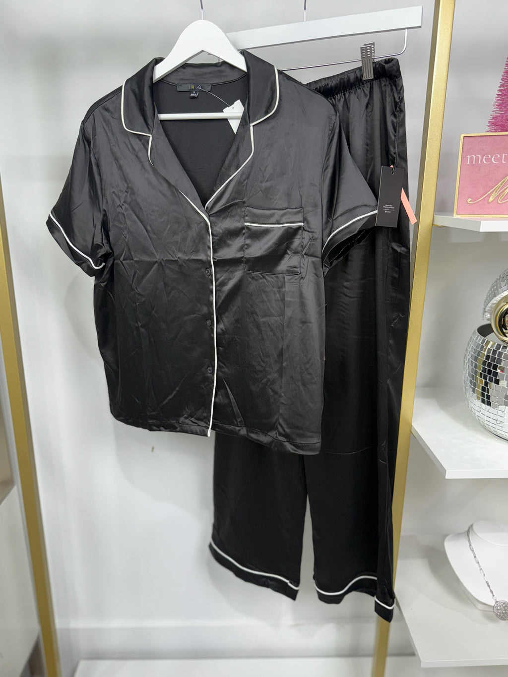 Relaxed cream pajama top with contrasting black piping and a pocket, perfect for chic evenings in Long Island boutique fashion.