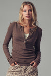 Model wearing brown ribbed Henley long sleeve top with button-up neckline — fitted everyday tee available at TandyWear Boutique in Commack, NY. front view