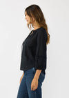 Elegant black frilled sleeve split neck blouse with textured detailing, perfect for casual chic style at a Long Island women's boutique.