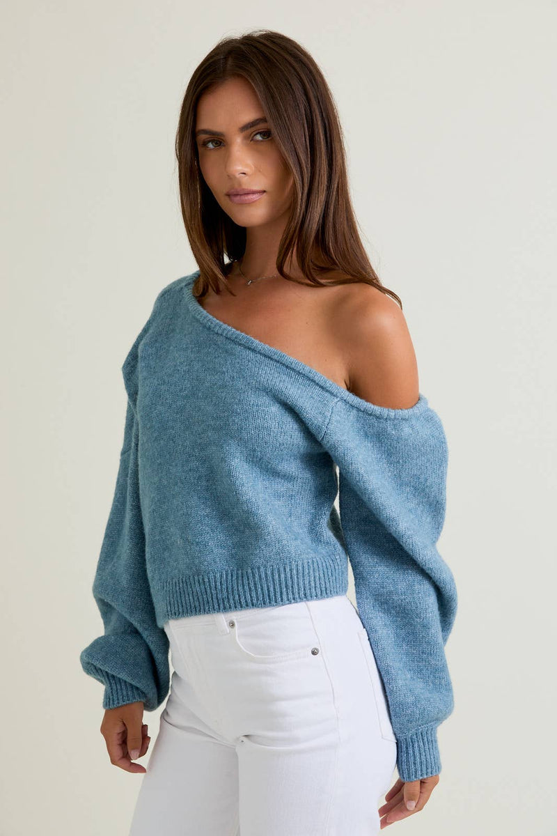 Light blue asymmetrical shoulder sweater top with relaxed fit and textured knit, perfect for cozy Long Island boutique fashion.