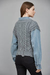 Cozy gray cable-knit sweater combined with a denim shirt, featuring a cropped fit and stylishly textured sleeves, ideal for Long Island boutique fashion.