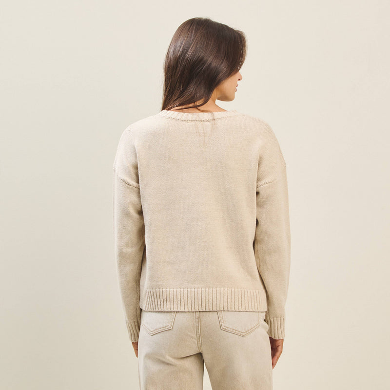 Beige Bow Dog Sweater with a relaxed fit and ribbed hem, perfect for cozy layers in Long Island boutique fashion.