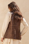 Brown faux leather snap-front vest with a relaxed fit, perfect for layering in stylish Long Island boutique fashion.