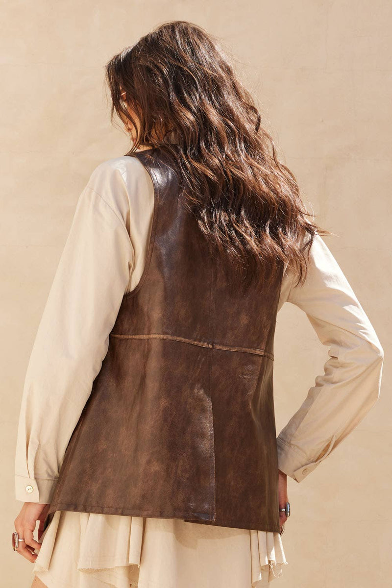 Brown faux leather snap-front vest with a relaxed fit, perfect for layering in stylish Long Island boutique fashion.