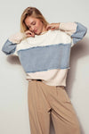 Distressed colorblock knit sweater featuring a soft cream, light blue, and denim design, embodying casual charm for Long Island boutique fashion.