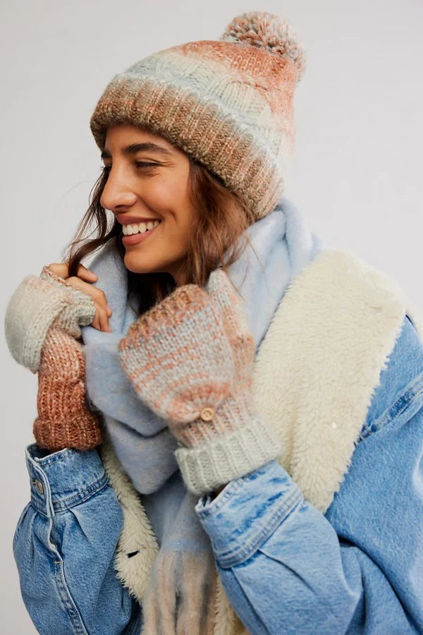 Cozy Free People rainbow hat and glove set features soft pastel hues, textured knit patterns, and a playful pom-pom, ideal for Long Island boutique fashion.