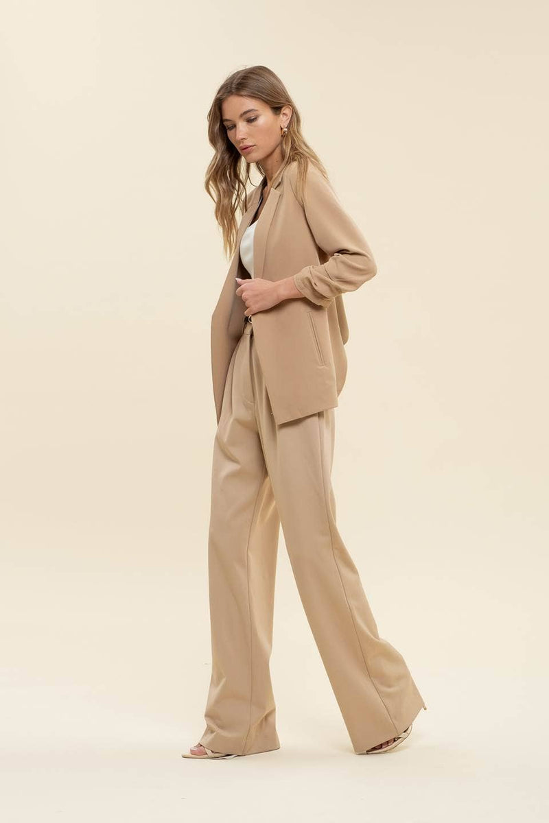 Beige 3/4 ruched sleeve blazer featuring a relaxed fit and clean lines, perfect for modern Long Island boutique fashion styling.
