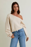 Cozy asymmetrical shoulder sweater top in soft cream, featuring oversized sleeves and a stylish cropped fit, ideal for Long Island boutique fashion.