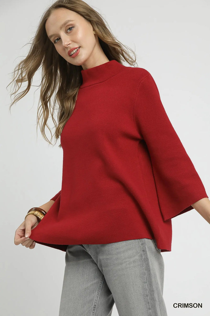 Cozy crimson top with a mock neck and bell sleeves, perfect for a stylish look from this Long Island fashion boutique.