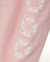 Soft pink Alex pants with white angel graphics, ideal for a trendy look in Long Island boutique fashion.