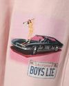 Light pink pants featuring a playful graphic of a woman with a golf club on a classic car, ideal for Long Island boutique fashion.