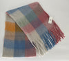 Plaid scarf with fringes and a tag on a white background