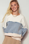 Colorblock distressed denim patchwork knit sweater featuring light blue and cream tones with frayed edges, perfect for Long Island boutique fashion.