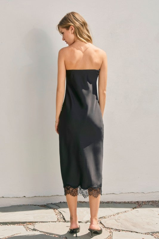 Strapless black dull satin midi dress featuring a delicate lace hem, perfect for elegant occasions in Long Island boutique fashion.