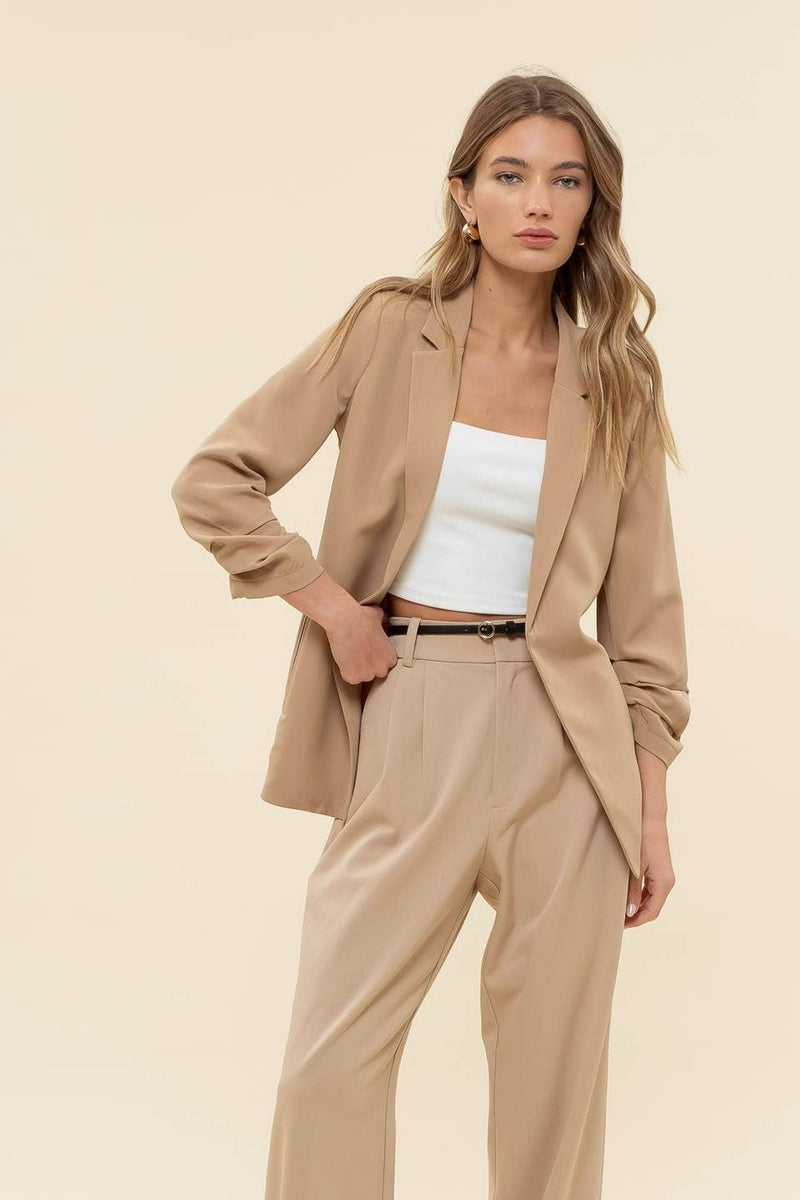 Lightweight beige 3/4 ruched sleeve blazer featuring a tailored fit, perfect for elevating any ensemble in Long Island boutique fashion.