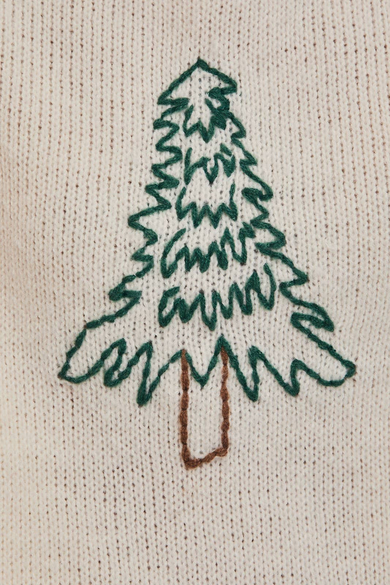 Cozy oversized sweater featuring a green embroidered Christmas tree on a soft beige background, ideal for Long Island boutique fashion enthusiasts.