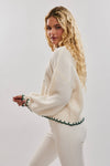 Oversized cream sweater with green "Christmas Tree" stitching and ribbed cuffs, perfect for cozy Long Island boutique fashion.
