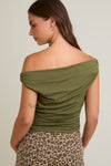 Model wearing dark olive off-the-shoulder ruched top in stretch knit fabric — fitted chic top available at TandyWear boutique in Commack, NY. back view 