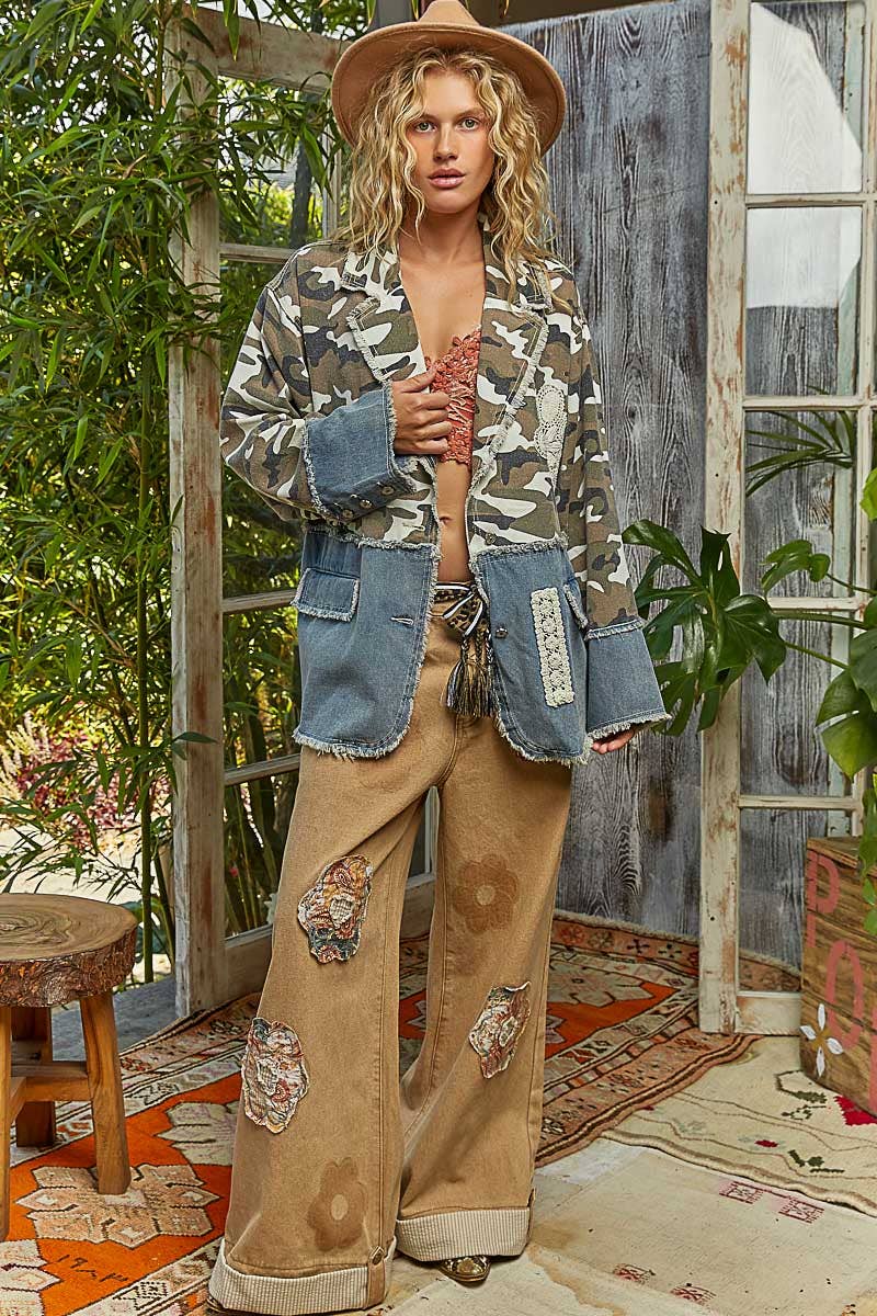 Relaxed-fit denim camo jacket featuring frayed edges and contrasting blue pockets, ideal for trendy Long Island boutique fashion.