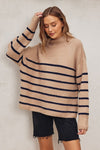Fluffy high neck sweater in a soft beige with bold navy stripes, featuring an oversized fit perfect for cozy Long Island boutique fashion.