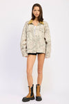 Oversized camo trucker jacket featuring a light gray and cream pattern with a contrasting mustard collar, perfect for Long Island boutique fashion.