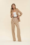 Light beige 3/4 ruched sleeve blazer paired with high-waisted trousers, embodying chic Long Island boutique fashion.