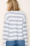 Super soft crew neck sweater featuring bold gray and white stripes, perfect for layering in Long Island boutique fashion.