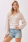 Stylish brush ribbed surplice long sleeve top in soft beige, featuring a flattering v-neck and balloon sleeves, perfect for Long Island boutique fashion.