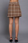 Brushed plaid mini skirt in warm browns and cream, featuring a fitted waist and a flared silhouette, perfect for Long Island boutique fashion.