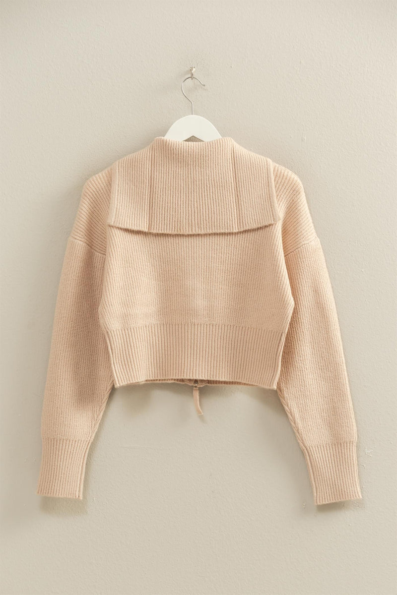 Cozy front zip collared cardigan in soft beige, featuring ribbed detailing and a trendy cropped fit, perfect for Long Island boutique fashion.