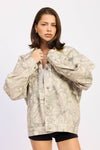 Lightweight camo oversized trucker jacket in earthy tones with an relaxed fit, perfect for layering, featured in this Long Island boutique fashion selection.