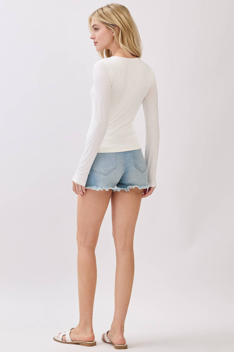 Fitted double layer V-neck long sleeve top in soft white, perfect for layering with shorts for a chic Long Island boutique fashion look.