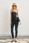 Sleek black dull satin tube top featuring a delicate lace hem, styled effortlessly with fitted black jeans, embodying Long Island boutique fashion.