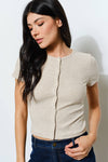 Soft beige ribbed button-up tee with short sleeves and a fitted silhouette, perfect for Long Island boutique fashion.