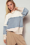 Distressed colorblock knit sweater featuring light blue and cream panels with raw edges, perfect for stylish layering in Long Island boutique fashion.