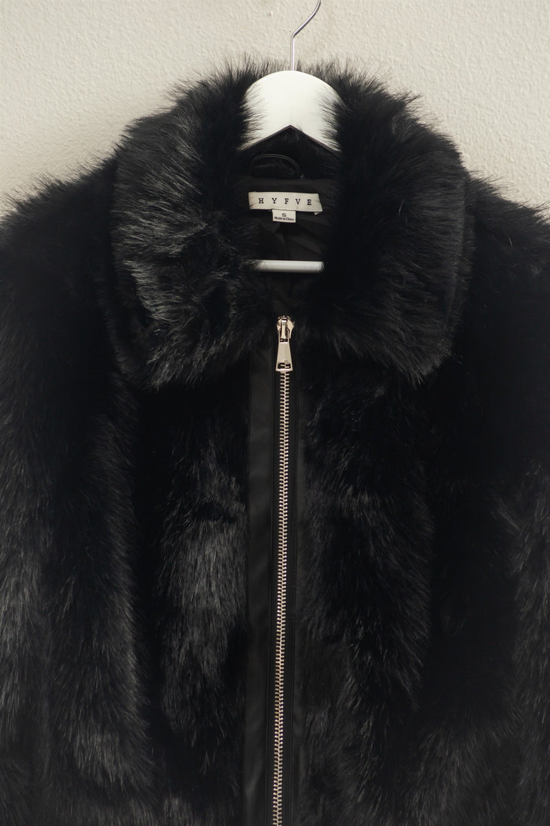 Luxurious black faux fur zippered jacket with a plush texture and a stylish stand-up collar, perfect for Long Island boutique fashion.