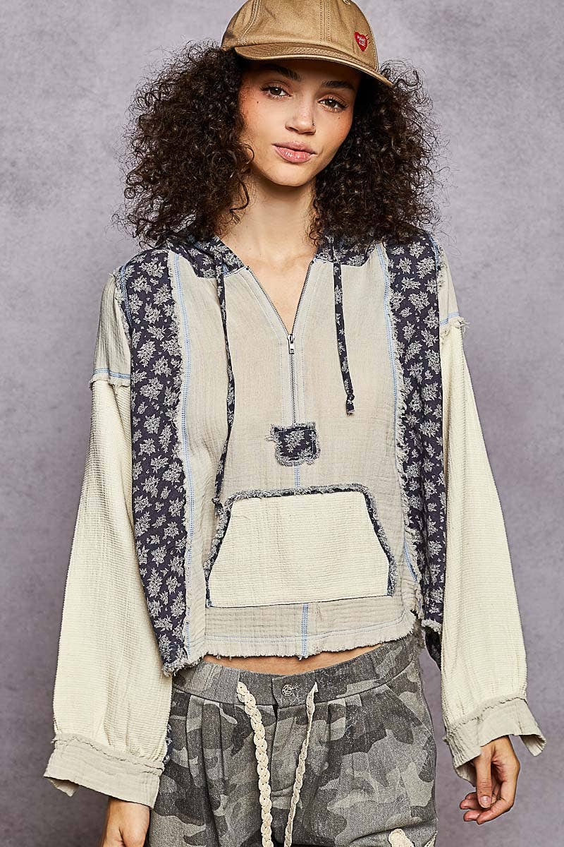 Color block gauze hoodie top features a cozy fit with a floral-patterned side and frayed hems, perfect for Long Island boutique fashion.