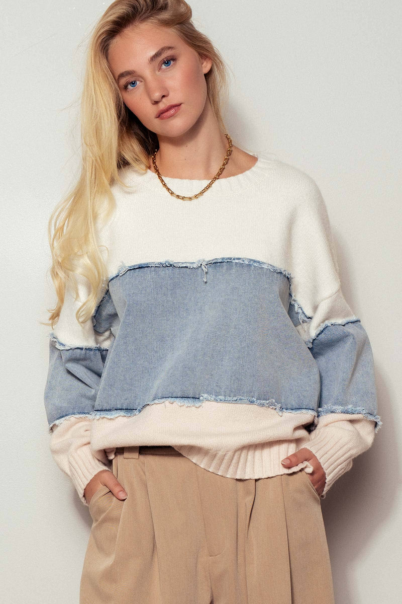 Cozy colorblock distressed denim patchwork knit sweater in white, blue, and soft pink, perfect for Long Island boutique fashion styling.