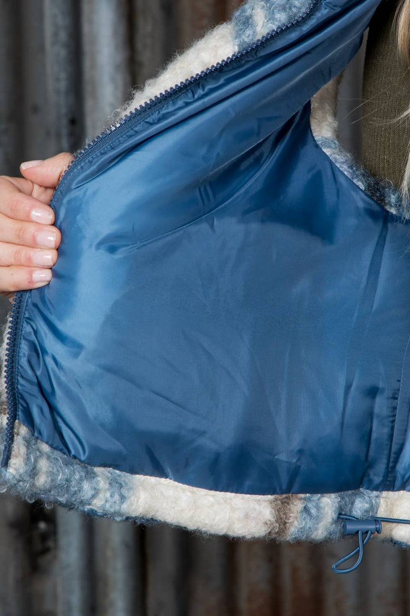 Curly Sherpa crop puffer vest featuring a soft, fluffy exterior in shades of blue and cream, perfect for cozy layering in Long Island boutique fashion.